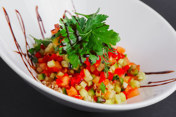 Lenten salad with tomato, marrow squash, cuscus, zucchini and paprika.