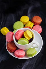 colorful macarons on black background