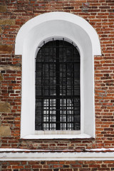 A fragment of a wall with a window arch type, secure window guards