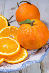 Giant ripe organic oranges from farm in Spain with leaves