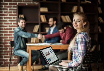 accountant works with financial charts on the laptop in the offi