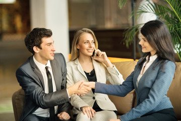 The girl with a big placard smiling and pointing to it with hi hand