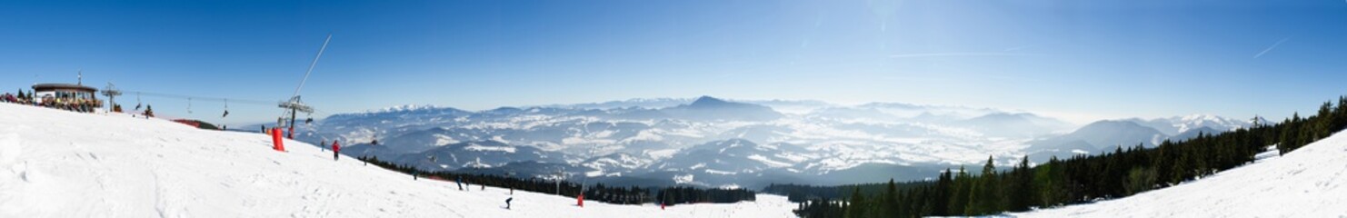 Panorama of chair lift on the top of ski slope of skiing park Kubinska Hola in winter. © hurvajs