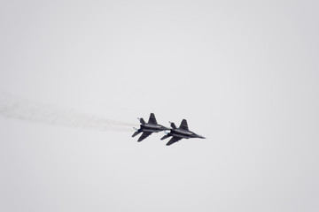 Air show in the sky above the Krasnodar airport flight school. Airshow in honor of Defender of the Fatherland. MiG-29 in the sky.