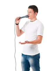 Young modern man with microphone isolated on white background