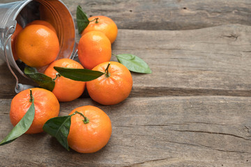 Fototapeta na wymiar Fresh tangerines with leaf