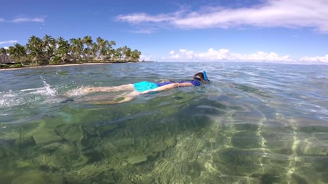 FJ 154 Woman snorkeling in a tropical resort in Fiji