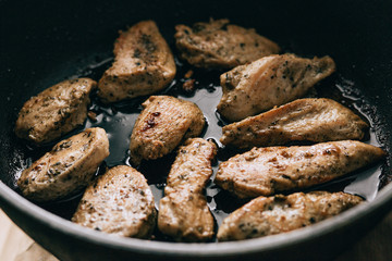 Cooking process. Fried chicken steak in a frying pan. fatty junk food