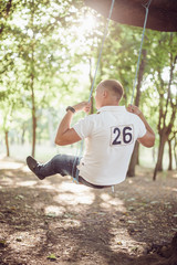 Man on swing in park