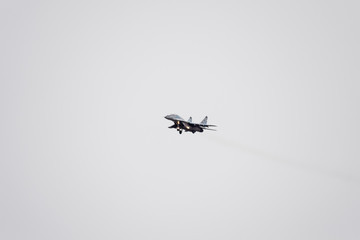 Air show in the sky above the Krasnodar airport flight school. Airshow in honor of Defender of the Fatherland. MiG-29 in the sky.