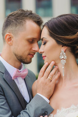 Young wedding Caucasian couple kissing outdoors