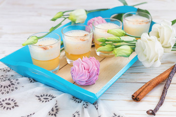 Eggnog, marshmallow dessert and white eustoma flowers. Easter concept