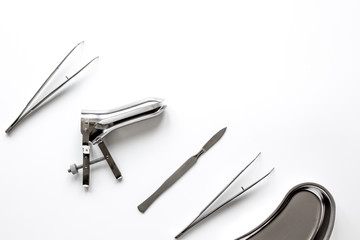 instruments of gynecologist on white background top view