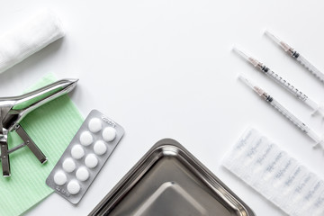 instruments of gynecologist on white background top view mock up