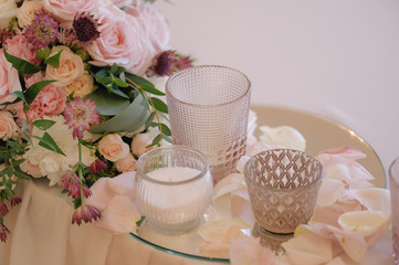 Beautifully decorated bouquet of roses in compose with candles