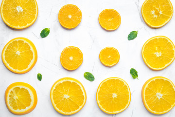 Fototapeta na wymiar Orange slices with mint on white background top view pattern