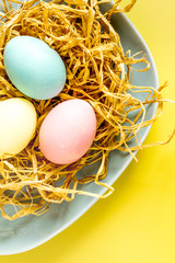 Easter concept eggs in nest top view close up