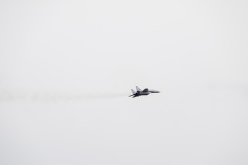 Fototapeta premium Air show in the sky above the Krasnodar airport flight school. Airshow in honor of Defender of the Fatherland. MiG-29 in the sky.