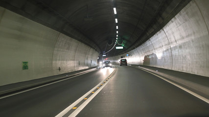 Light and projected shadows inside the Vedeggio-Cassarate road tunnel with lights,signs and traffic