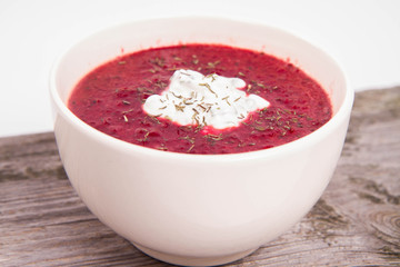 Beetroot cream soup decorated with yoghurt mixed with chives