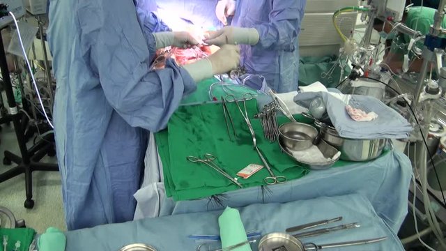 Nurse preparing instruments for heart valve surgery