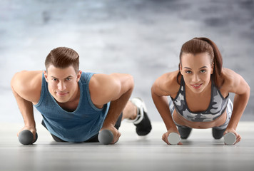 Young sporty couple training in gym