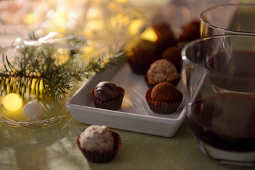 Glasses of wine with assorted chocolates on table closeup