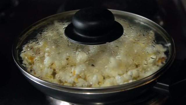 Popcorn explodes in a frying pan, HD footage