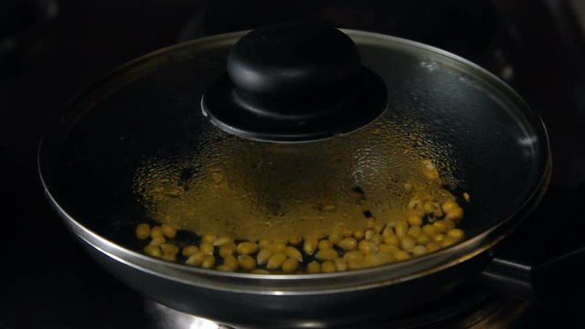 Popcorn explodes in a frying pan, HD footage