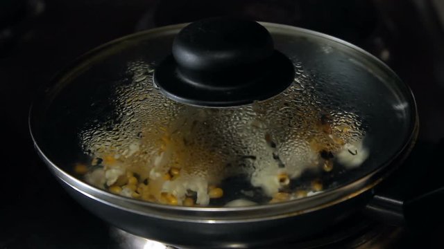 Popcorn explodes in a frying pan, HD footage