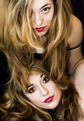 Fototapeta premium Two beautiful women Portrait over Black Background
