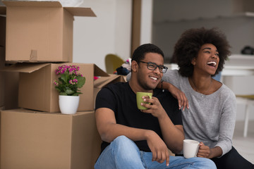 African American couple relaxing in new house