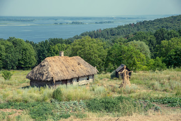 old wooden house on a hill near the river