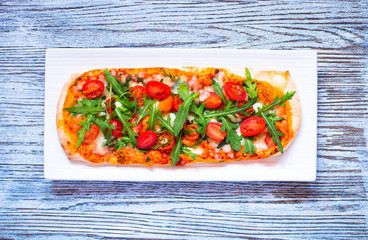 Home maid fresh pizza with tomatoes, rucola and mozzarell