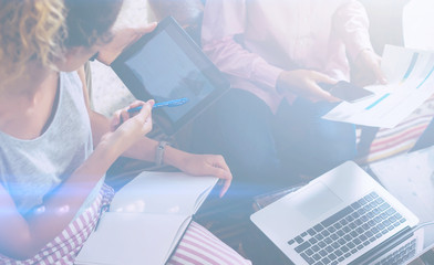 Closeup view of teamwork work process.Young business team working with new startup project.Notebook on table,smartphone,tablet and reports.Blurred background, visual effect. Horizontal