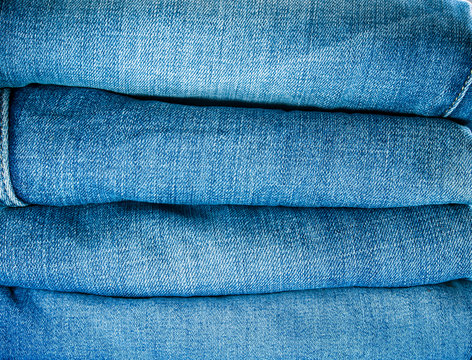 Pile of blue jeans, fabric texture
