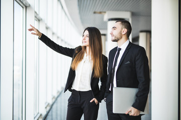 Businesspeople Planning New Office. Business woman pointed with hands on windows