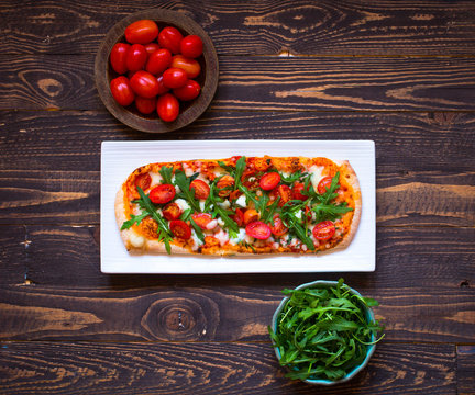 Home maid fresh pizza with tomatoes, rucola and mozzarell