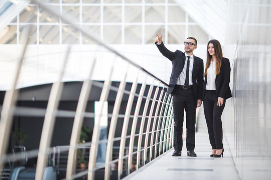 Businessman and Businesswomen having informal meeting in office and discussing plans. Woman pointed.