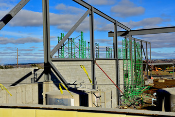 Large steel and concrete block commercial building under construction.