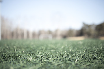the artificial grass football ground : for usage of background, intentionally defocused.