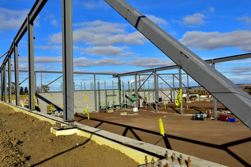 Large steel and concrete block commercial building under construction.