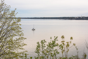 Calm blue bay in Washington during sunset with boat in water