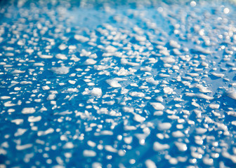 Obraz premium the snow melts on a blue background in the sun