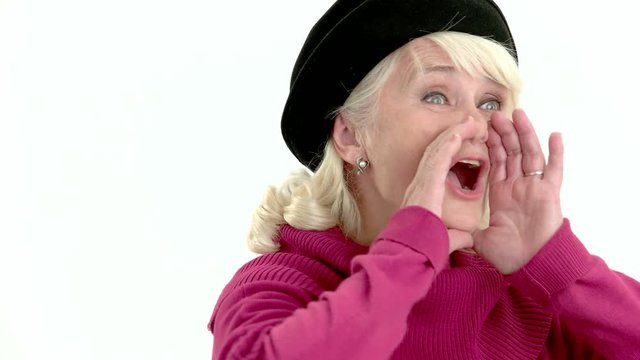 Senior lady is shouting. Woman holds hands near mouth.
