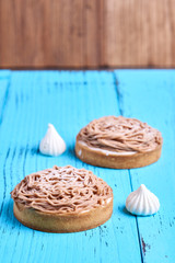 Two round small chestnut cakes or tarts, with copy space on logo