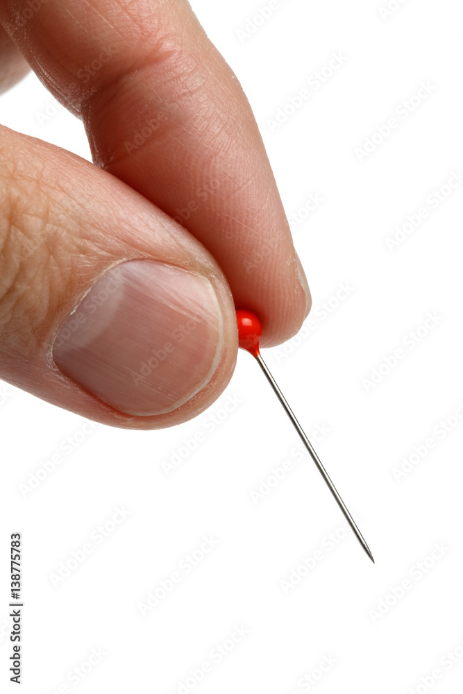 Wall mural hand holding a pin with a red head