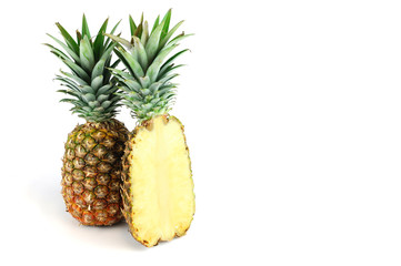 whole pineapple and cut in half isolated on white background