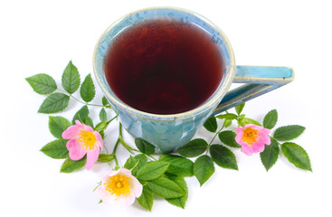 Cup of tea and wild rose flower on white background