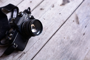Analog film camera on wooden background